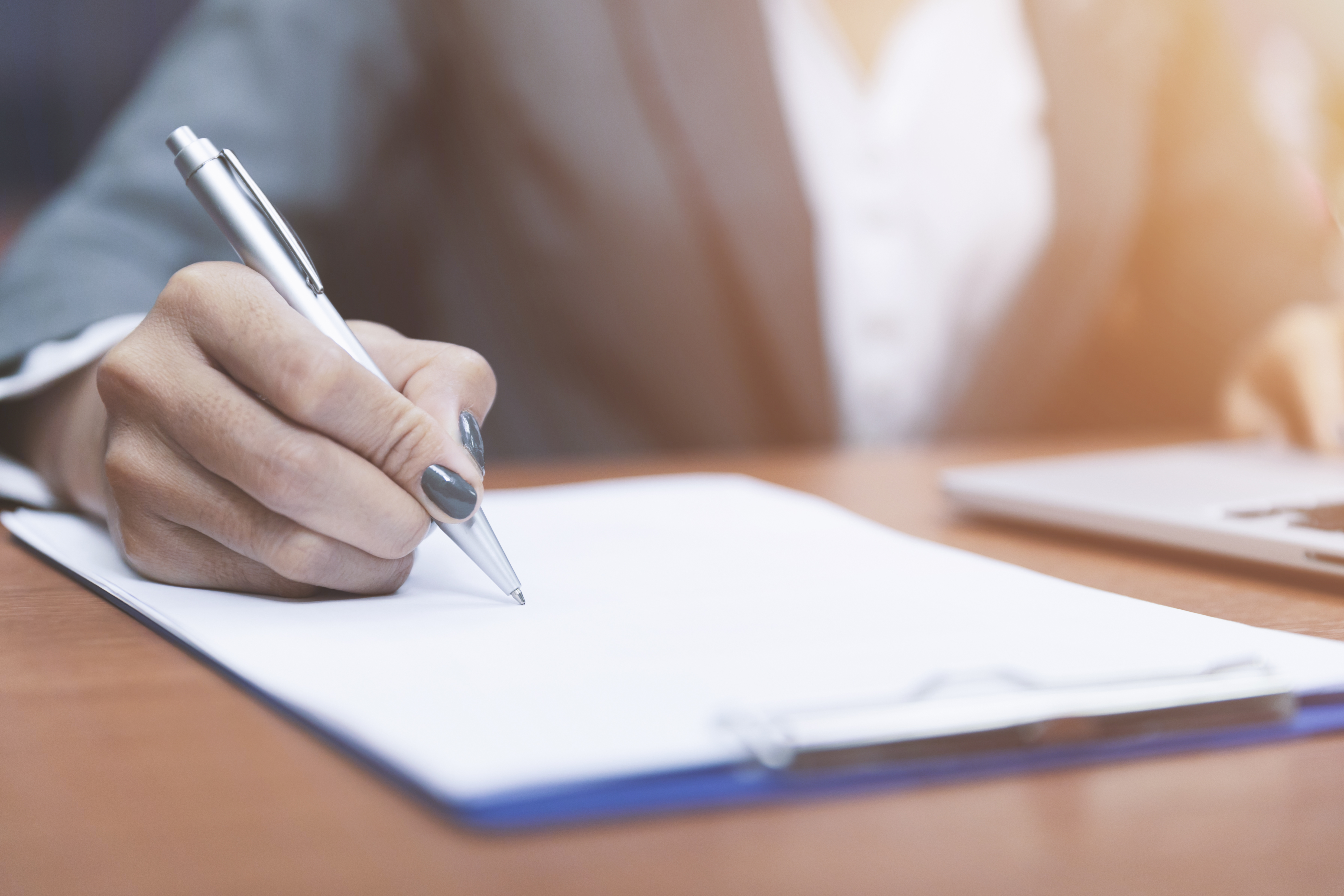 33096202-close-up-hand-of-woman-holding-pen-thinking-and-writing (1).jpg